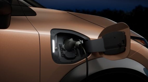 Close-up image of charging cable plugged in | Nissan of Visalia in Visalia CA